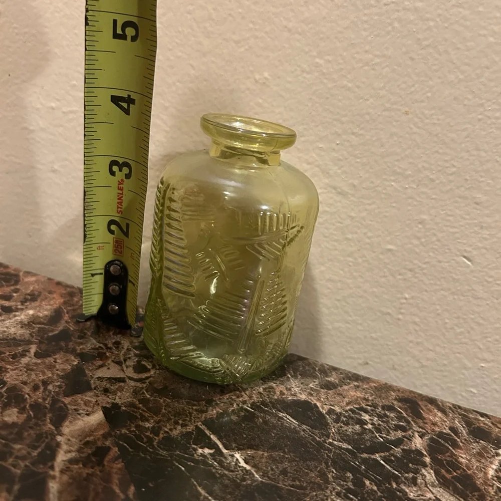 yellow iridescent glass vase with a leaf etching